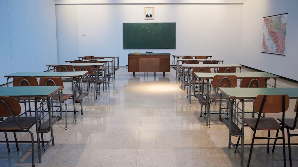 Illustrative classroom with desks and a teaching board