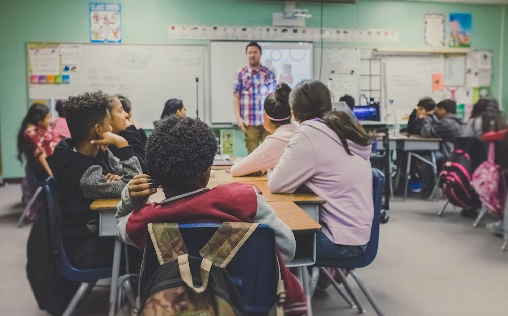Teacher supporting learners in a classroom
